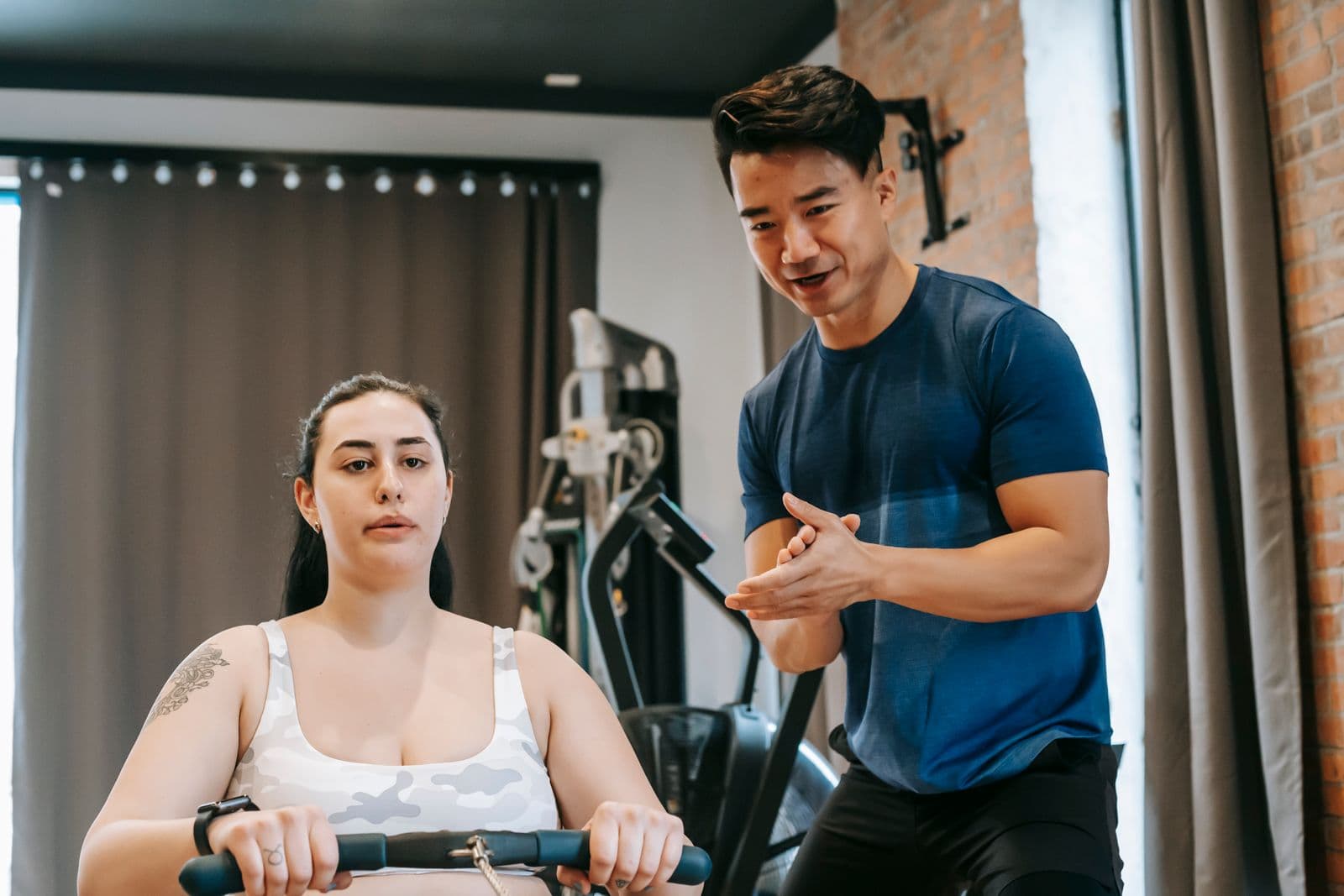 A coach working one-to-one with a client in a gym