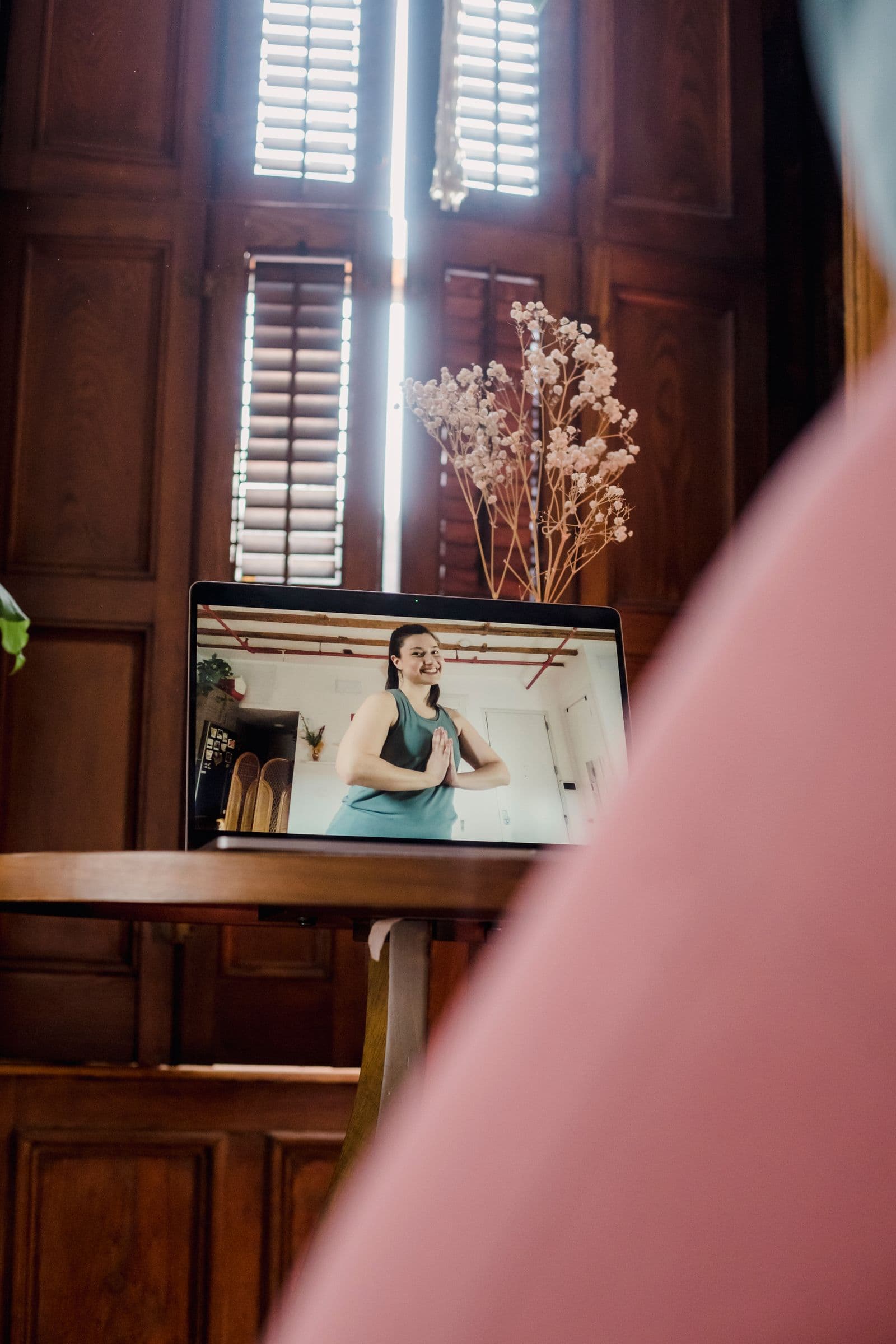 A coach working with a client remotely on a laptop